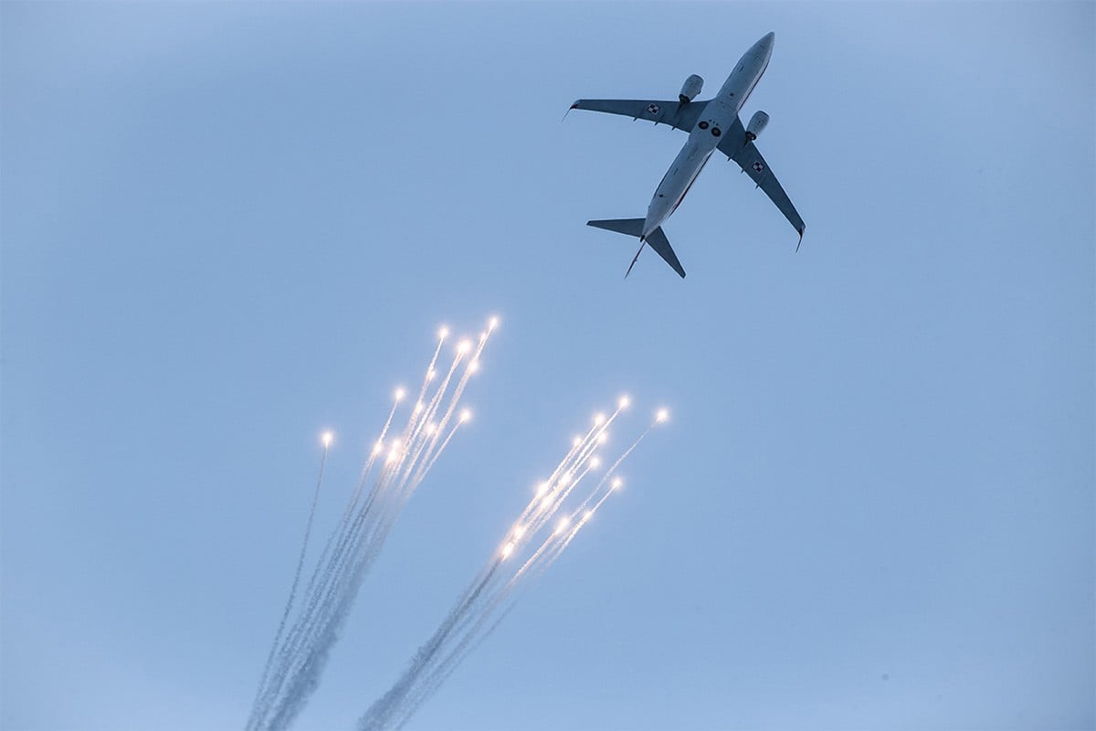 Aircraft in the air, ejecting flares