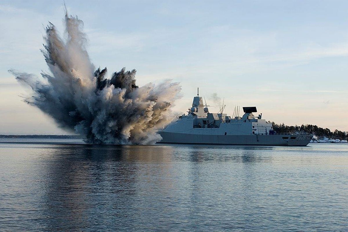 Water cascades at sea, close to surface ship